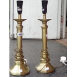 A pair of modern metal table lamps with brass effect finish
