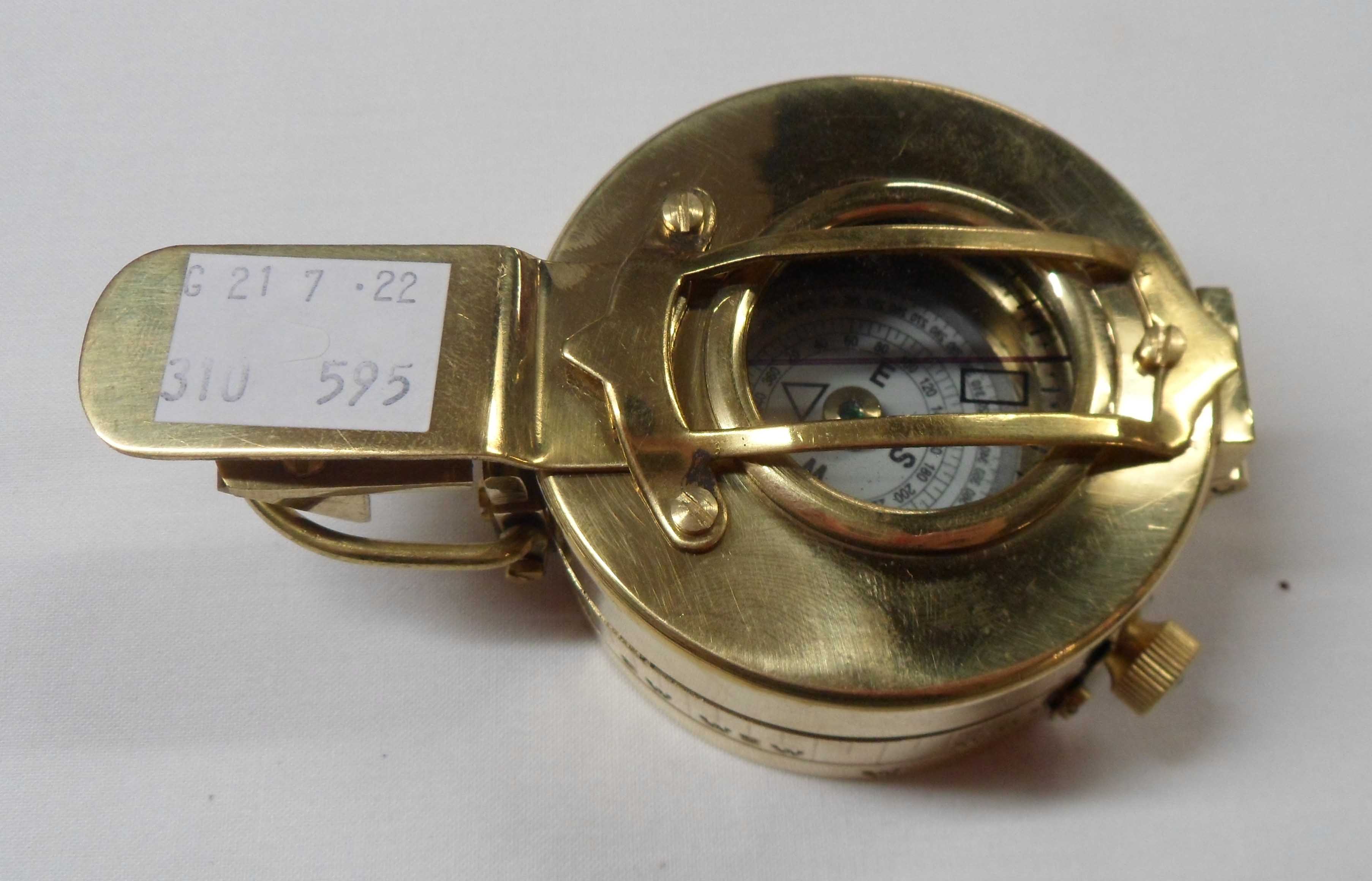 A modern reproduction brass military style compass