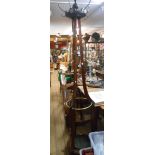 An antique freestanding mahogany hat and coat stand with brass hooks and retaining rail, swept