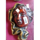 A modern German pottery wall mask in the Art Deco style depicting a lady with scarf, decorated