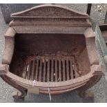 An old cast iron fire basket with curved front grill