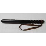 An old turned wood police truncheon with original leather strap