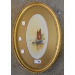 An ornate oval gilt framed watercolour, depicting a fishing vessel with figure in a rowing boat,