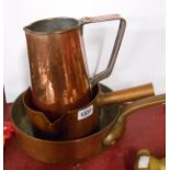An old Lyon Jaggi & Sons. Ltd. copper saucepan, a larger saute pan with brass handle and a beaten