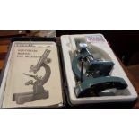 A vintage cased student's microscope kit - sold with an adjustable swan neck table magnifying