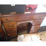 A 69cm antique mahogany kneehole desk with long frieze drawer, blind drawer under, six flanking