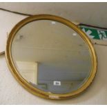 An old gilt framed bevelled circular wall mirror - with part restoration