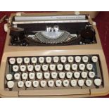 A vintage Empire Corona Delux typewriter in original hard shell case