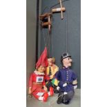 Three vintage puppets comprising a clown, policeman and a jester