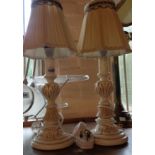 A pair of vintage cast plaster table lamps of candlestick form with shades