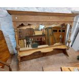 A 1.63m antique style oak overmantle mirror with bevelled plate and turned supports - from a