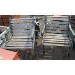 A pair of garden chairs with cast iron ends and slatted wooden seats