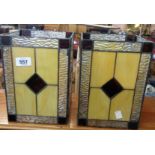 A pair of modern hall lantern shades with decorative stained glass effect panels