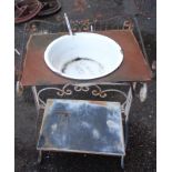 An old metal two tier washstand with enamel wash bowl