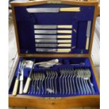 A vintage quarter sawn oak canteen containing a quantity of assorted cutlery - various patterns