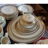 A quantity of Losolware dinner china decorated with a gilt Greek key border and brown transfer