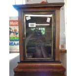 A two shelf display cabinet fashioned from an old mantel clock case