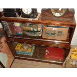 An 89cm retro polished mixed wood Minty two section modular bookcase enclosed by glass sliding