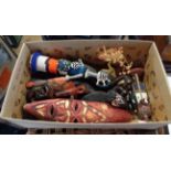 A box containing a quantity of collectable items including carved African figures and masks,