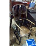 An antique Windsor hoop stick back elbow chair with moulded solid elm seat, set on turned supports -
