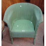 A vintage Lloyd Loom tub chair with original green sprayed finish and card label - sold with a