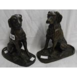 A pair of old hollow cast brass figures depicting seated dogs with bronze effect finish