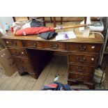 A 1.22m 20th Century mahogany twin pedestal desk with leather inset top, central frieze drawer and
