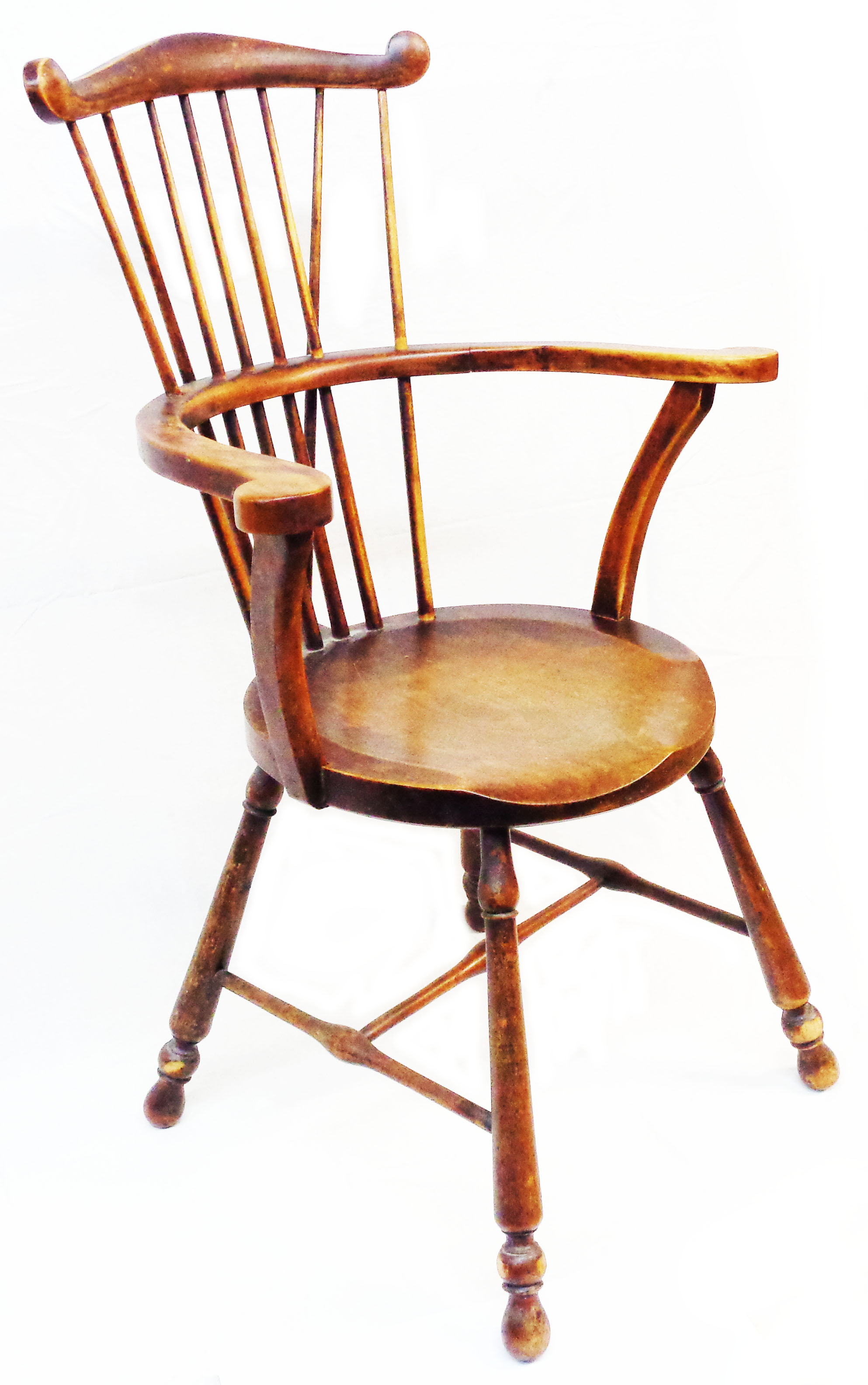 A 19th Century comb back Windsor elbow chair with solid moulded seat, set on turned supports