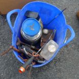 A bucket containing G-clamps, woodworking wax and oils