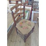 An old rustic oak ladder back dining chair with tapestry upholstered seat