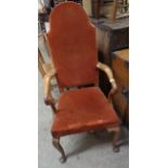 An early 20th Century Queen Anne style high panel back elbow chair with russet velour upholstery,