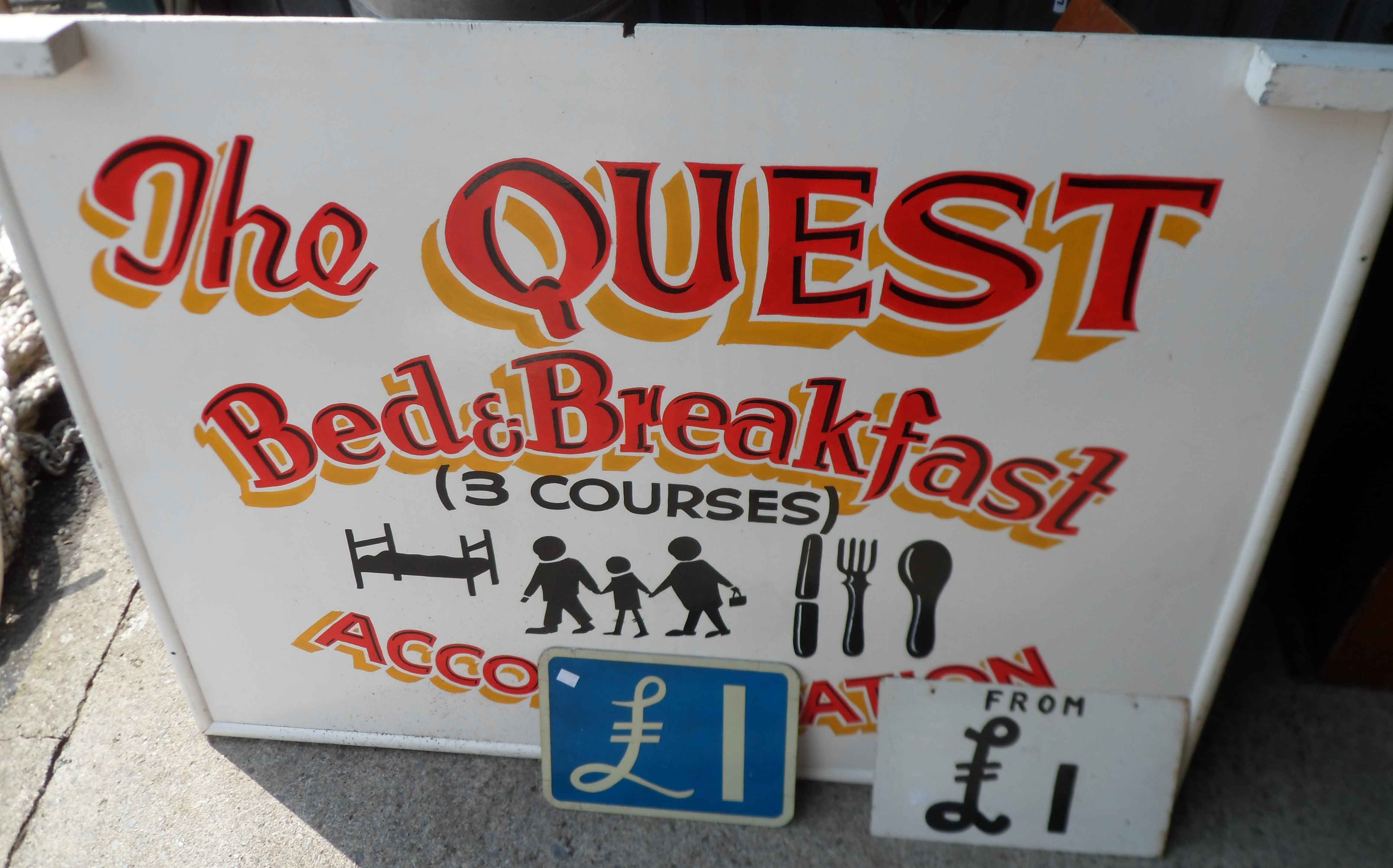 A large hand painted sign for The Quest Bed and Breakfast - sold with two metal "£1" signs