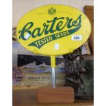 A vintage oval wooden painted Carters Tested Seeds advertising sign, set on later wood and chrome