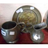 A pewter tankard with glass dartboard base, a Britannia metal jug and a decorative brass dish
