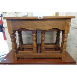 A 20th Century oak nest of three tea tables, set on turned supports