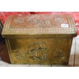 A brass clad wooden fireside coal box with embossed galleon decoration
