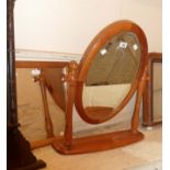 A modern pine framed swing dressing table mirror with bevelled oval plate - sold with a small pine