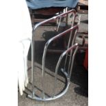 A modern chrome plated three bar towel rail