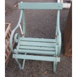 An old wrought iron garden chair with wooden slats and later painted green finish