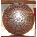 A circular tabletop inset with a display of British pre-decimal coinage including pennies,