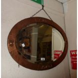 A 70cm vintage copper clad framed bevelled oval wall mirror with embossed decoration