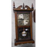 A Highlands stained wood cased wall clock with visible pendulum and thirty one day gong striking