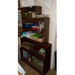 An 89cm retro polished mixed wood Minty two section modular bookcase enclosed by glass sliding doors