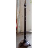 An early 20th Century mahogany and simulated rosewood standard lamp with decorative pillar and
