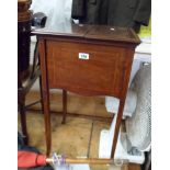 An Edwardian mahogany and strung worktable with bi-folding top opening to reveal a fitted