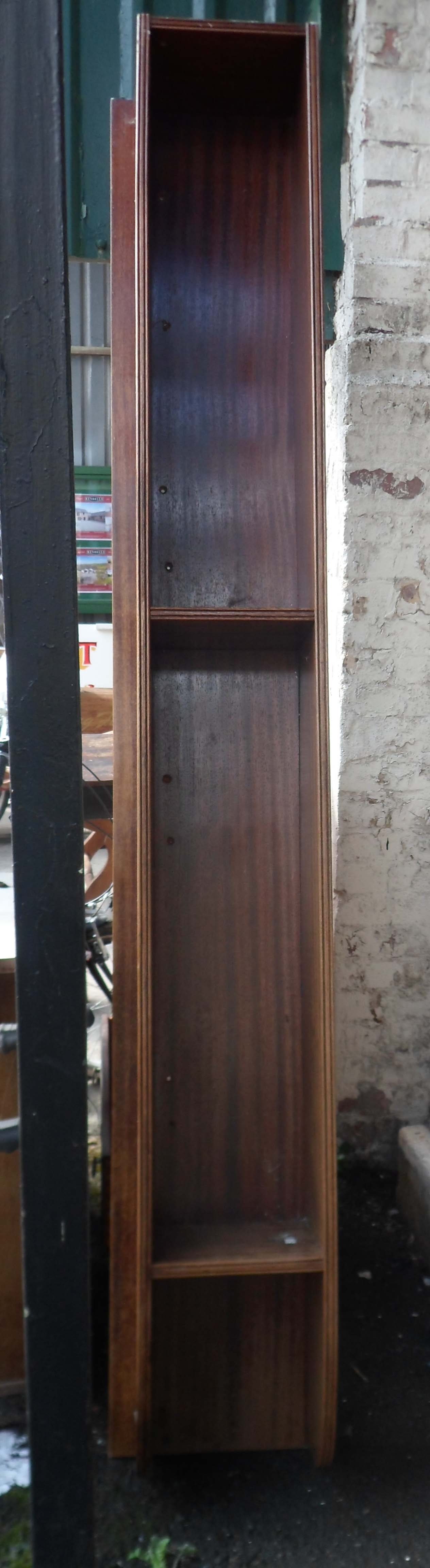 A large mahogany wall mounted book shelf