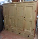 A 1.72m Victorian painted pine scullery cupboard with shelves enclosed by two pairs of panelled