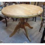 A 91cm modern pine circular pedestal dining table, set on turned pillar and quadruple legs