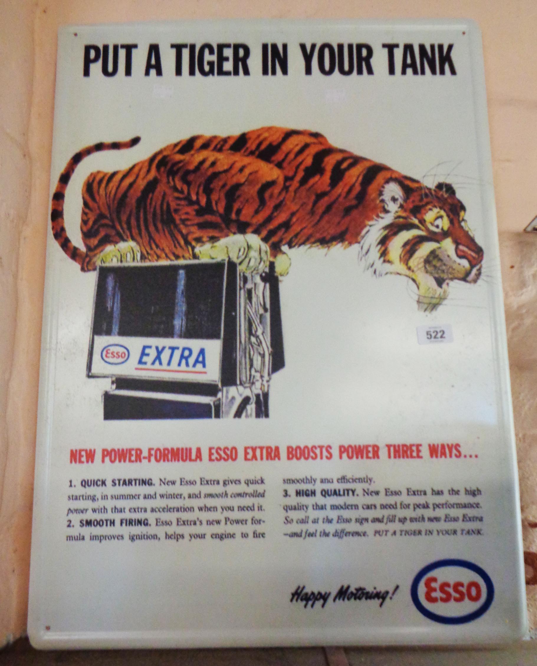 A modern printed tin Esso tiger advertising sign