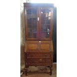 A 76cm vintage oak two part bureau/bookcase with glazed top section over a part fitted interior